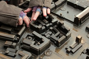 Colleen reading braille on a tactile map of Cambridge