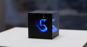 A black cube with a glowing blue number 5 in the center