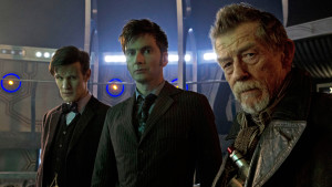 The 3 Doctors stare into the camera in the TARDIS