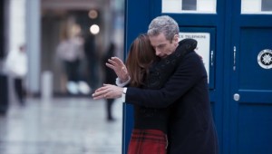 Clara hugs the Doctor outside the TARDIS, and the Doctor awkwardly puts his arms around Clara